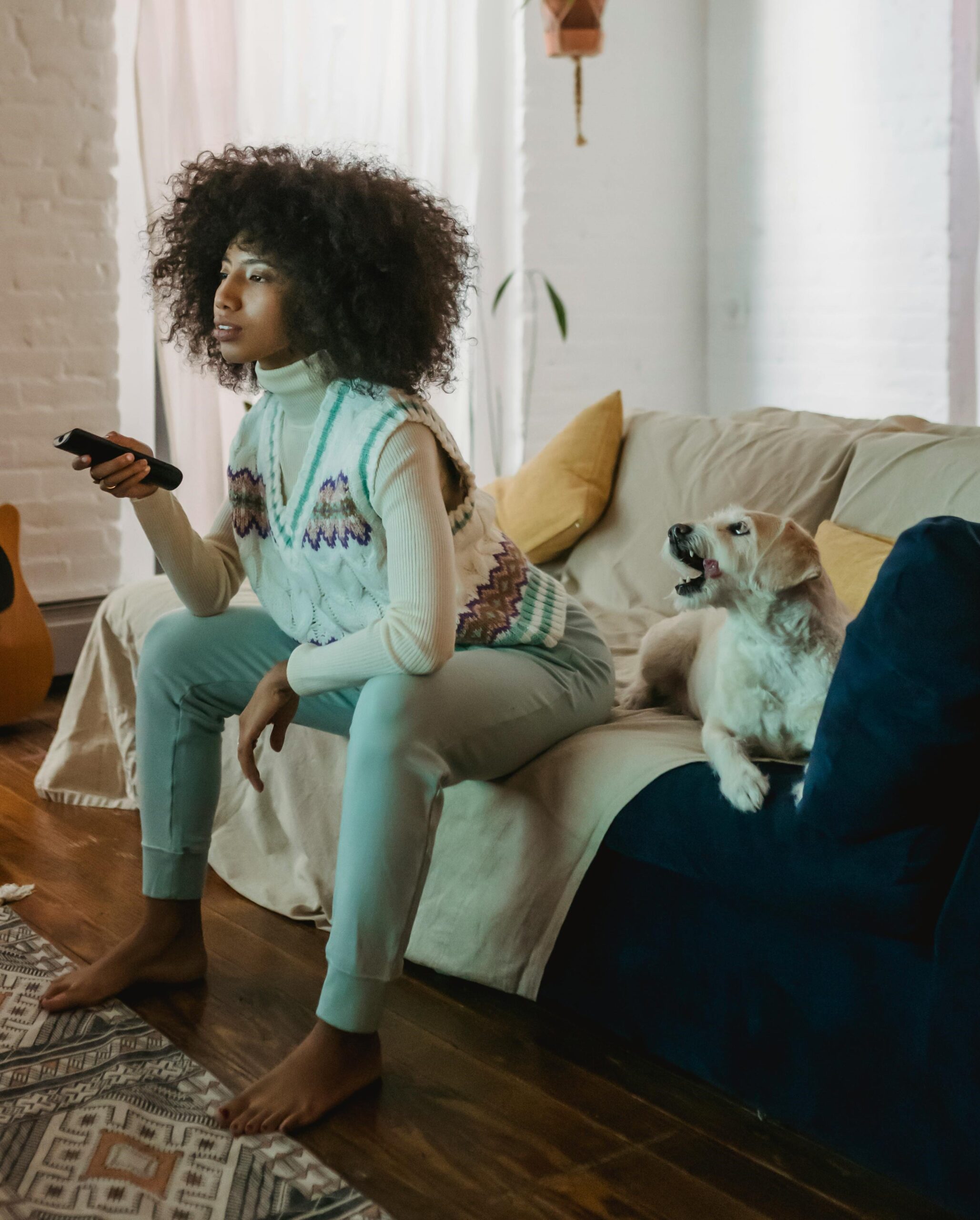 Woman watching television with her dog