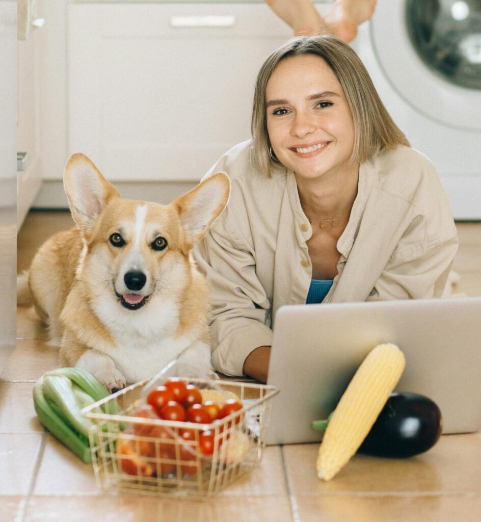 Woman and dog searching internet on how to make homemade dog food